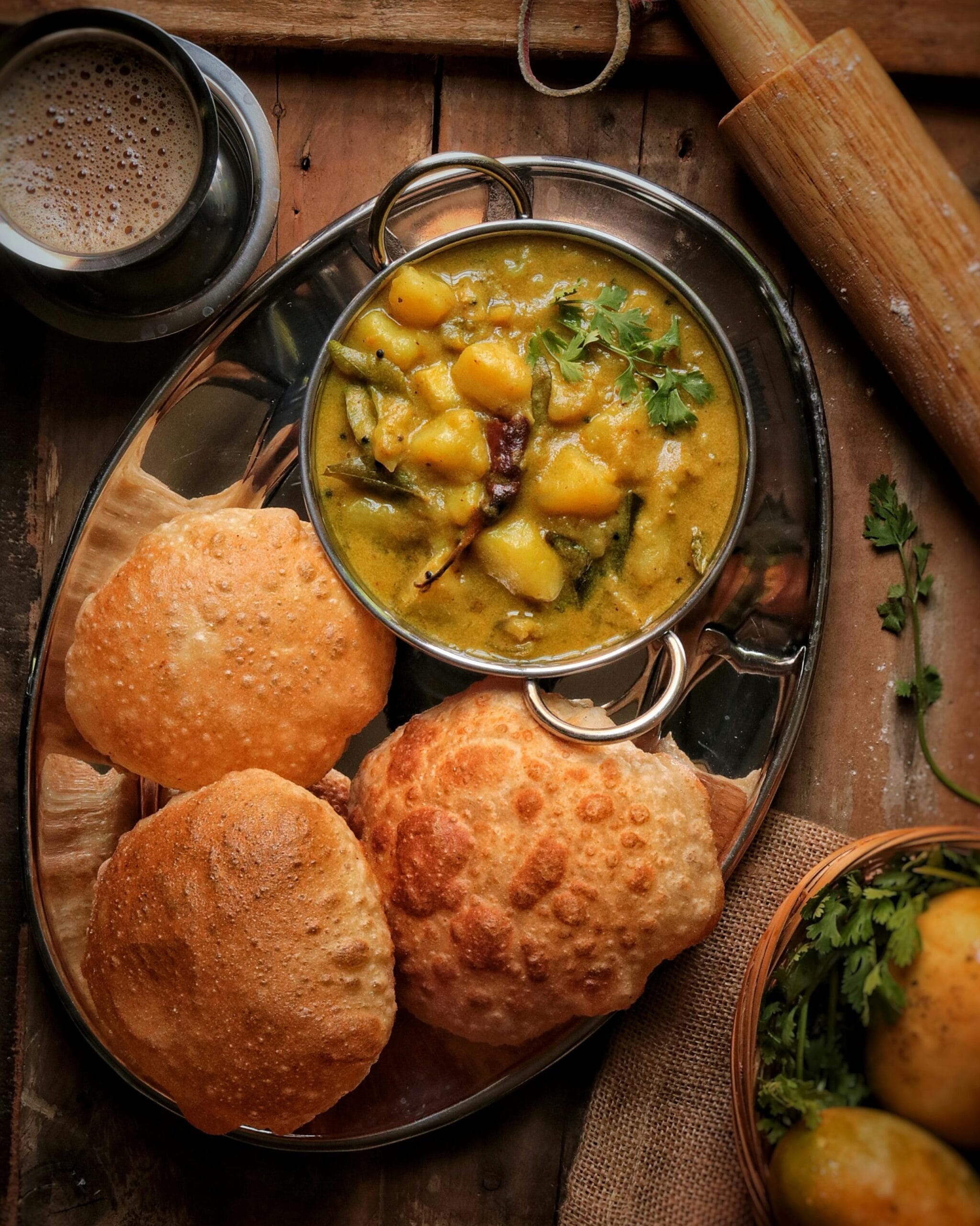 pexels photo 8617361 8617361 Top view of a traditional potato curry with bread served on a wooden table, perfect for rustic dining.